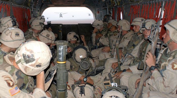 Soldiers from 2nd Battalion, 327th Infantry Regiment, fly aboard a CH-47D Chinook helicopter en route to their objective -- a village in west Iraq. The 101st Airborne flew 450 kilometers from its bases in northern Iraq to search five villages 50 kilometers from the Saudi Arabia-Iraq border.