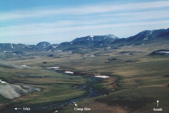 A view to the south of the camp site, with 89-00176 at 200 feet AGL hovering in a photo op.