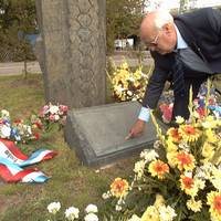 At a memorial plaque at the city airport in Mannheim, Germany, Peter Kibble-White finds the name of his son Paul, a Welsh skydiver who died in a U.S. helicopter crash on 11 September 1982.