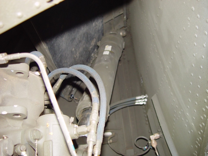 July 2002: A closer view inside the wheel well for the left aft landing gear. The long cylinder extending upwards to the top of the well is the aft landing gear strut. It absorbs the shock of the landing up to the design limit of the actuator during landings to reduce the impact imparted to the fuselage and rotor system.