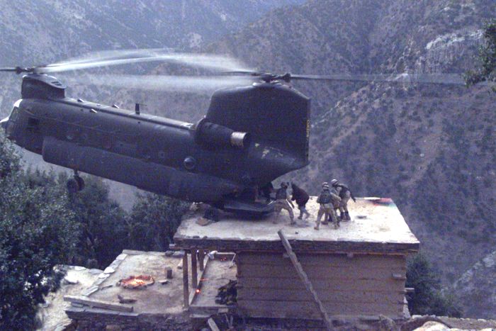 91-00264, a CH-47D, lands on the roof of a house in Afghanistan to pick up suspects during Operation Mountain Resolve, approximately November 2003.