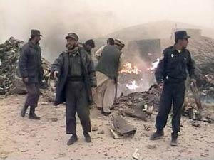 Afghans attempt to extinguish the remains of a U.S. military CH-47D Chinook helicopter which crashed during a dust storm in Ghazni province, 120 km southwest of the capital of Kabul in this image taken from television footage on 6 April 2005.