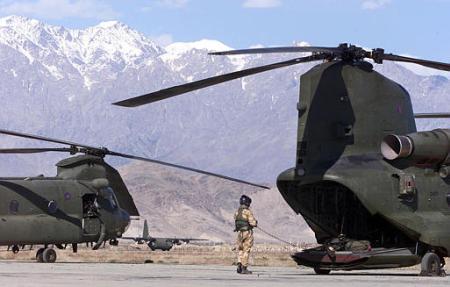 A British Royal Air Force (RAF) HC Mark II crew member performs preflight checks on the runway at Bagram Air Base.