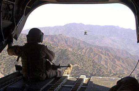 A crew member of a CH-47D Chinook helicopter stands watch over the ramp.