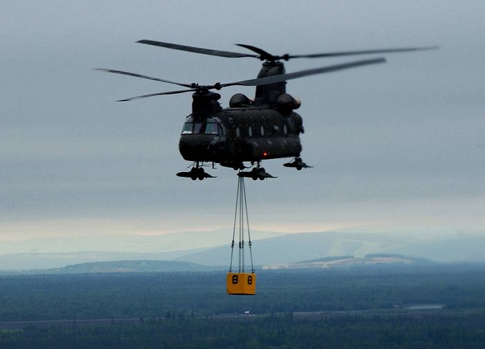 Alaska, 18 June 2004: Soldiers aboard a CH-47D Chinook helicopter (tail number unknown) depart Fort Wainwright and approach a landing zone on Eielson Air Force Base during exercise Northern Edge in Alaska. The Soldiers are assigned to B Company - "Sugar Bears", 4th Battalion, 123rd Aviation Regiment. The joint exercise is designed to enhance interoperability among the military services.