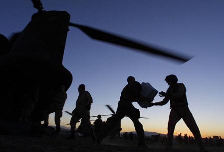 Soldiers of the 10th Mountain Division and a Bravo Company - "Hercules", 159th Aviation Regiment, 18th Aviation Brigade, flight crew unloaded aid supplies from a U.S. CH-47D Chinook helicopter in Nahrin, northern Afghanistan.