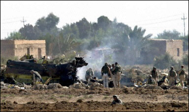 US soldiers inspect the site where a Chinook helicopter was shot down outside the flashpoint town of Fallujah, 50km (30 miles) west of Baghdad.