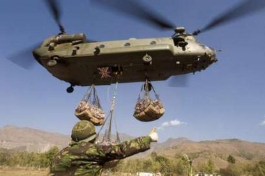 16 November 2005: A member of the Joint Helicopter Support Unit gives the thumbs-up sign to a Royal Air Force Chinook helicopter carrying loads of relief supplies in Muzaffarabad, capital of Pakistan-administered Kashmir. The United Nations and British military launched a huge airlift of food and tents to earthquake survivors high in Pakistan's mountains on Wednesday as Islamabad appealed to the world for more money. Two Royal Air Force Chinook transport helicopters hovered low over an air strip on the outskirts of the ruined city of Muzaffarabad while a British military team on the ground hooked up nets filled with the first of hundreds of tonnes of supplies.